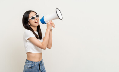 Shout out loud with megaphone. Young beautiful asian woman  announces with a voice about promotions...