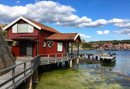 traditional red  cabin on a pontoon in front of the sea  under blus sky in sweden -Fjallbacka