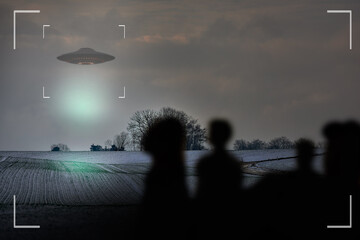 UFO, alien and camcorder on a camera display to record a flying saucer in the sky over area 51....
