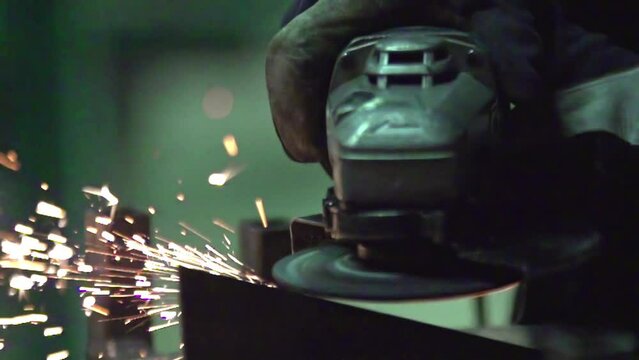Sandpaper or industrial mechanical saw working and giving off sparks. Slow motion shot.