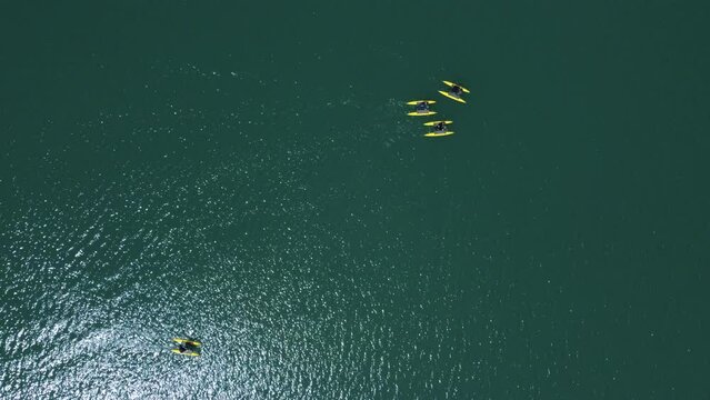 Bird's eye view of people on Hydrobikes. Drone shot of water bikes in lake Plastira | 4K