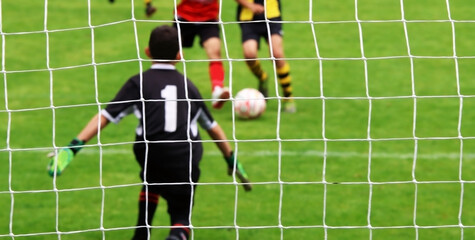 Soccer goal, with the goalkeeper in the foreground. Selective focus