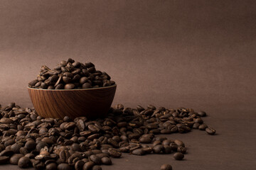 High quality roasted Colombian coffee beans, great flavor and aroma, presentation on a light brown background