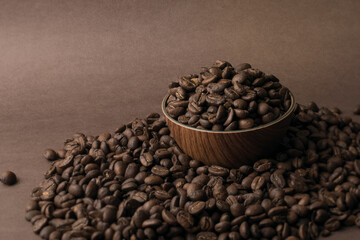 High quality roasted Colombian coffee beans, great flavor and aroma, presentation on a light brown background