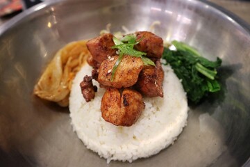 Dish of rice, chicken, spinach and kimchi with sesame seeds on the top. korean dish menu.