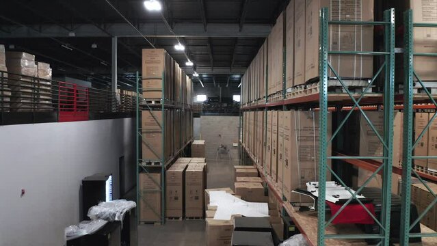 Aerial, identical cardboard boxes on pallets racks in shipping storage warehouse