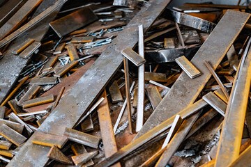 Metal waste after processing and cutting metal at the factory in the workshop. Scrap metal. Recycling of metal waste.