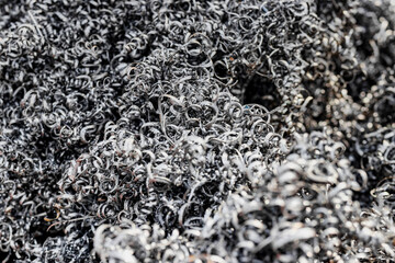 A lot of metal shavings close-up, after working on a milling machine or CNC machine. Texture metal shavings. Recycling of waste. Ecology. Saving resources.