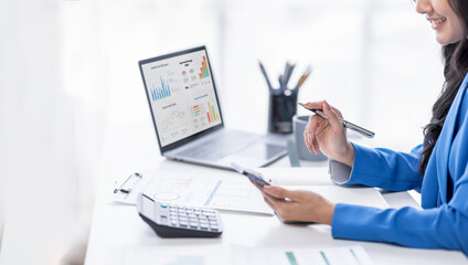 Financial Businesswomen analyze the graph of the company's performance to create profits and growth, Market research reports and income statistics, Financial and Accounting concept.	