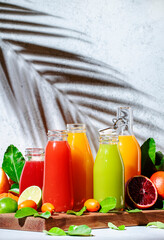 Summer fruit juices and smoothies, food background. Mix of different whole and cut fruits: orange,...