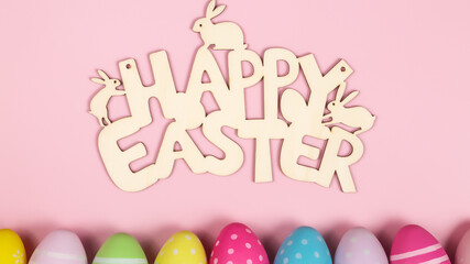 happy easter background greeting card concept text with decorated flat easter eggs on a pastel pink