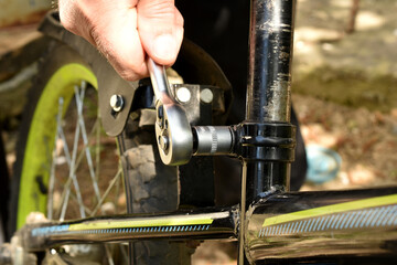 Bicycle repair with a ratchet wrench.