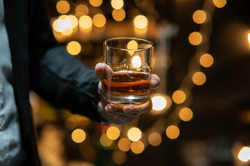 Barman pouring whiskey whiskey glass beautiful night