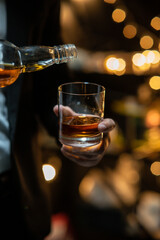 Barman pouring whiskey whiskey glass beautiful night