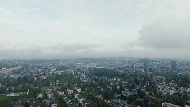 Aerial view of City of Zürich with skyline and skyscrapers on a cloudy spring morning. Movie shot May 9th, 2023, Zurich, Switzerland.