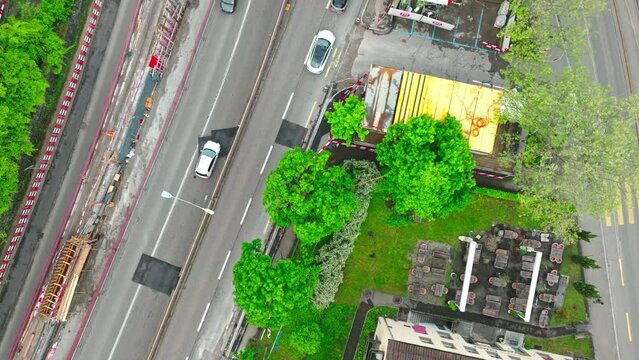 Top view of urban road with traffic and construction site at City of Z&uuml;rich on a cloudy spring morning. Movie shot May 9th, 2023, Zurich, Switzerland.