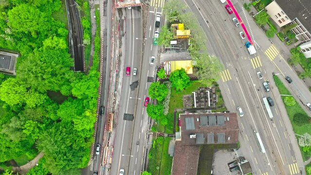 Top view of urban road with traffic and construction site at City of Zürich on a cloudy spring morning. Movie shot May 9th, 2023, Zurich, Switzerland.