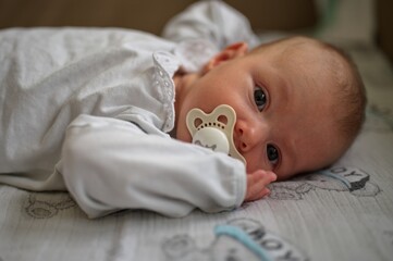 Portrait of little baby girl lying on the sofa