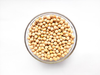 Whole dried White pea or yellow pea or trapper peas on glass bowl.Top view of whole peas isolated on white background.Peas has many culinary use and rich with high protein,vitamins and antioxidants.