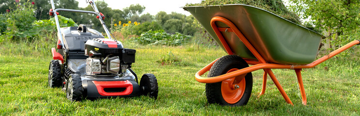 Lawn mover on green grass in modern garden. Machine for cutting lawns.
