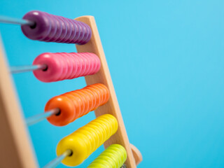 Wooden abacus on a blue background, Wooden abacus for children.