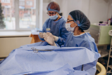 A phlebologist performs an ultrasound of the legs for varicose veins using a modern