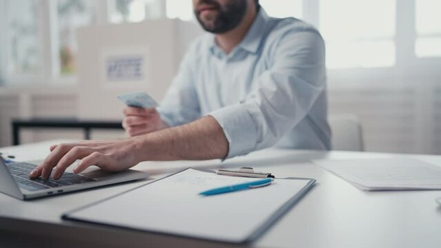 Polling station clerk processing voters on election day, giving out ballot