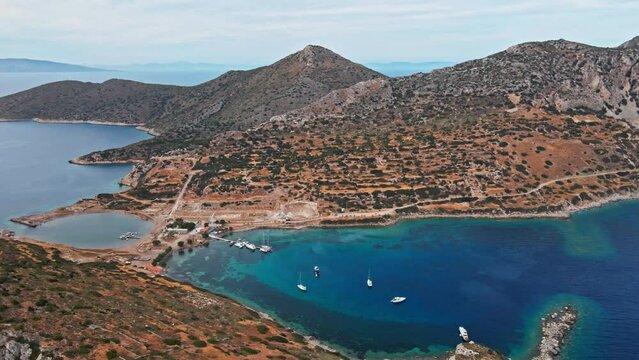 View from above, aerial view of a transparent and turquoise sea with some boats and yachts. Mediterranean sea coast, Knidos Ancient city, Datca, Turkey. Summertime vacation and travel to seaside