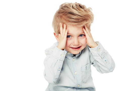 Portrait, child and peeking from hands in studio isolated on a white background mockup space. Smile, peekaboo and boy kid playing game, happiness and having fun while enjoying quality time alone.