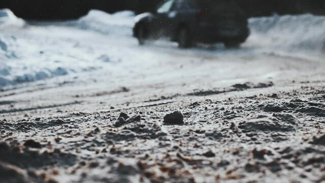 Close up detail of car drift in snowy street. Wheels raise up the mud and snow. Sport race transport in wintertime. Speed riding, gas burning. Drag racing car burn tire at start line. Vehicle concept