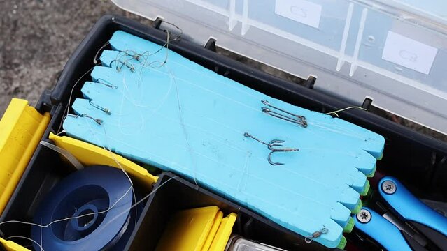 Fishing tackle box, fully stocked with fishing tackle. A set of fishing lures and accessories. Various fishing equipment.