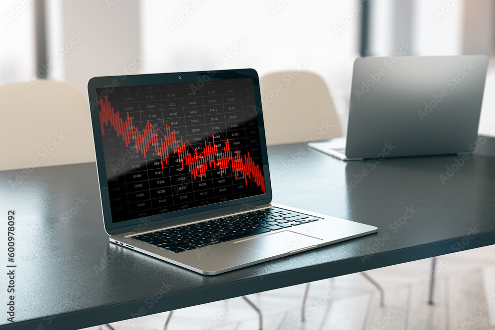 Poster close up of laptop on desktop with falling red business graph grid on blurry office background. cris
