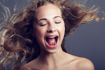 Beauty, eyes closed and hair care of woman shouting in studio isolated on a gray background. Natural, makeup cosmetics and skincare of female model with long hairstyle, growth and salon treatment.