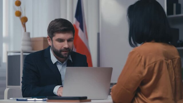 Friendly UK embassy official giving passport to woman acquiring citizenship