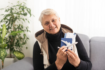 old woman with tickets and a toy airplane