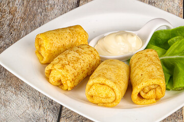 Stuffed pancakes with cream sauce
