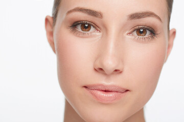 Fototapeta premium Portrait, beauty and woman with dermatology, skincare and confident girl isolated against a white studio background. Face, female person and model with organic facial, treatment and grooming routine