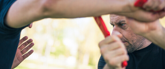 Knife vs knife fight combat training. Sumbrada training method. Plastic weapon defend demonstration drill