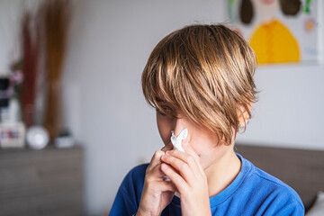 Child boy blow his nose. Allergic kid, flu season. Kid with cold rhinitis, get cold snot nose....