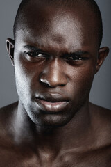 Portrait , serious and black man with skincare, cosmetics and dermatology against a grey studio background. Face, male person and model with beauty, salon treatment and luxury with grooming routine