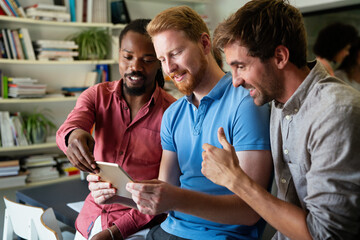 Group of happy startup business people having fun and chatting at workplace office