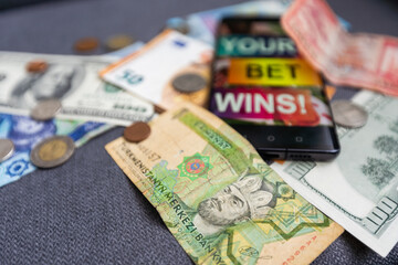 dollars and euros, smartphone with sports bet application