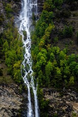 Obraz premium Drone shot of waterfall in the forest, Aosta Valley, Italy