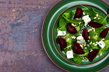 Fresh salad with beets, cheese and greens.