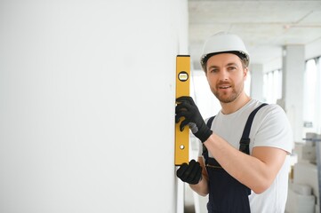 A happy worker proudly standing at his workplace.