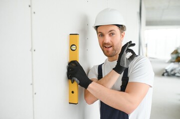 Professional Workman Applying Silicone Sealant With Caulking Gun on the Wall