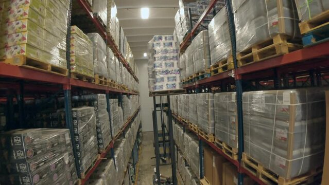 Forklift Stacking Goods On The Rack In The Warehouse Stockroom. FPV drone