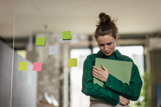 Young sad woman in office, having problem.
