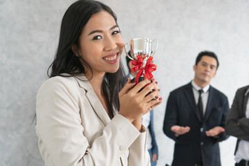 young female business people proud with her prize and her team appreciate with her success