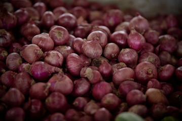 Pile of Organic red onions at vegetable market